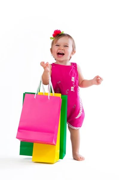 Menina doce em design rosa e azul com sacos de papel isolados no fundo branco . — Fotografia de Stock
