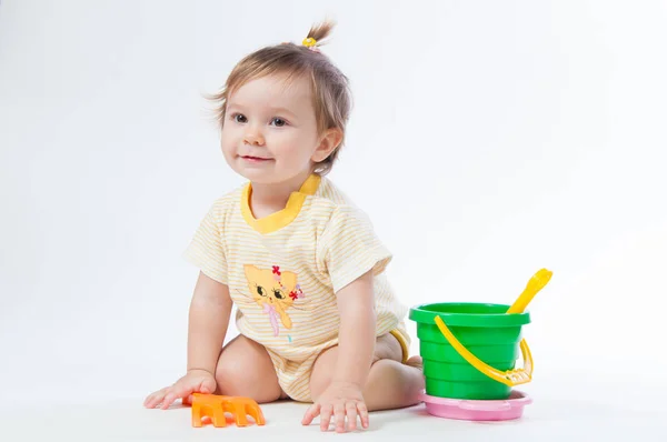 Cute baby with bucket and spade isolated on white background — Stock Photo, Image