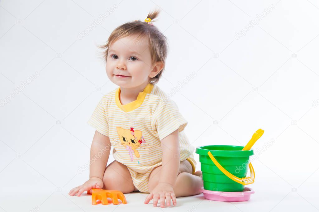 Cute baby with bucket and spade isolated on white background