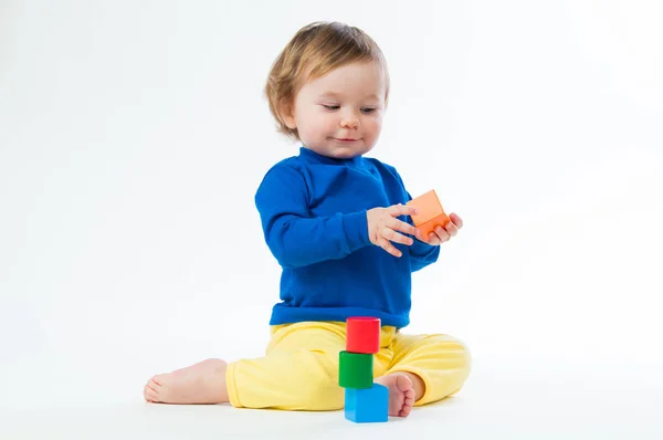 Little child playing with dices isolated on white background — Stock Photo, Image