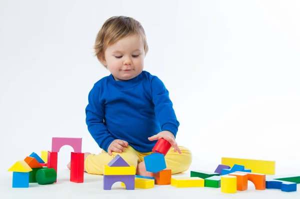 Little child playing with dices isolated on white background — Stock Photo, Image