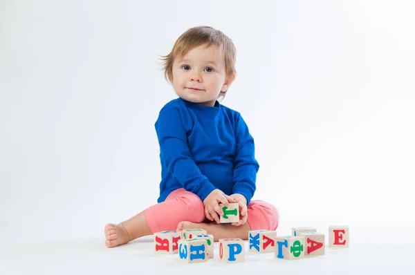 Little child playing with dices isolated on white background — Stock Photo, Image