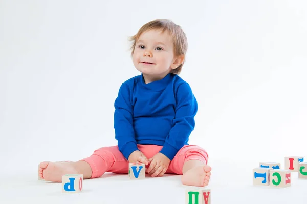 Little child playing with dices isolated on white background — Stock Photo, Image