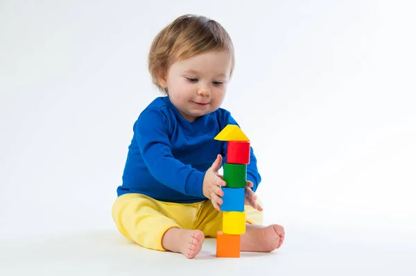 Little child playing with dices isolated on white background — Stock Photo, Image