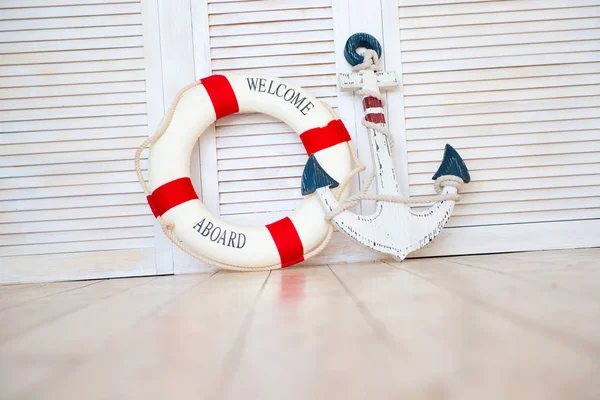 Composition on the marine theme with anchor and lifeline on wooden background — Stock Photo, Image