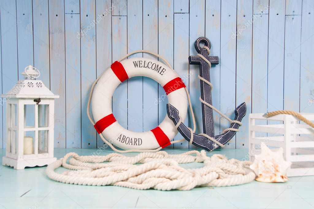 Decor in the style of sea travel. Anchor and lifebuoy, lantern