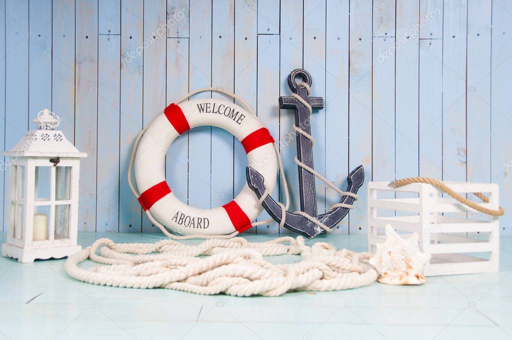 Decor in the style of sea travel. Anchor and lifebuoy, lantern