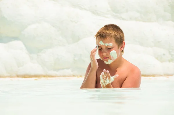 The child swims in the Pamukkah tram. Wellness baths. — Stock Photo, Image