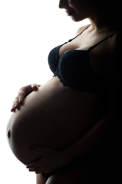 Silueta femeii gravide pe un fundal alb — Fotografie, imagine de stoc