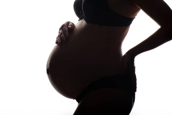 Silhuett av gravid kvinna på en vit bakgrund — Stockfoto