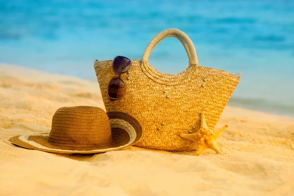 Bolsa de sombrero y gafas en la playa . — Foto de Stock
