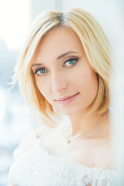 Portrait of a young blonde woman with blue eyes. — Stock Photo, Image