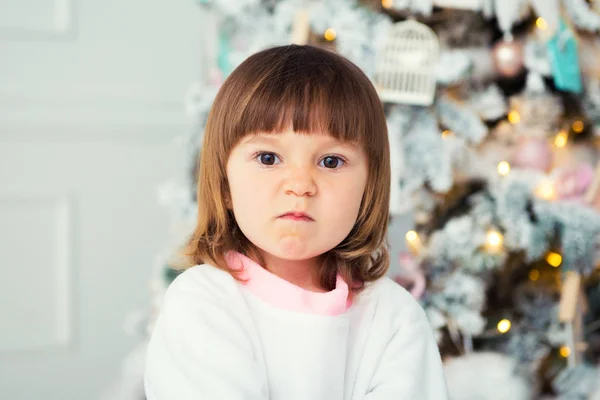 Little girl emotions. Brooding and grimace. Problem of choice. Close-up in the interior. — Stock Photo, Image