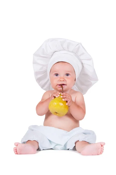 Bambino Piccolo Sta Mangiando Una Pera Nel Vestito Dello Chef — Foto Stock