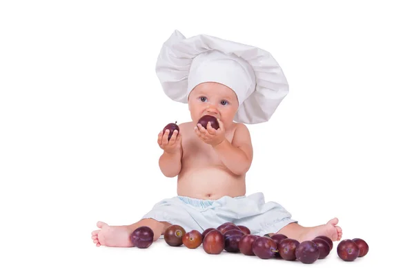 Ein Kleines Kind Isst Pflaumen Kochanzug Auf Weißem Hintergrund — Stockfoto