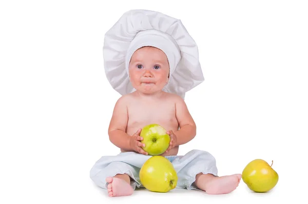 快乐的小孩子, 手里拿着苹果, 穿着白色背景的主厨套装。. — 图库照片