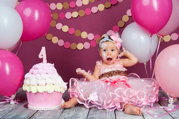 Retrato de uma menina de aniversário alegre com o primeiro bolo. A comer o primeiro bolo. Bolo de esmagamento — Fotografia de Stock