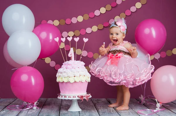 Das Geburtstagskind des kleinen Mädchens wurde in eine Torte geschmiert. der erste Kuchen. die Verwendung des ersten Kuchens. Kuchen zerschlagen. — Stockfoto