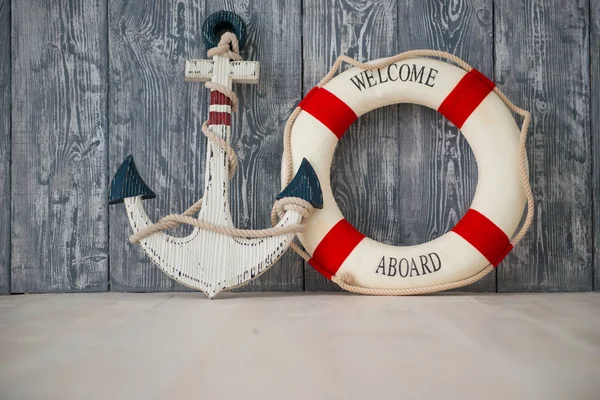 Composition on the marine theme with anchor and lifeline on wooden background — Stock Photo, Image