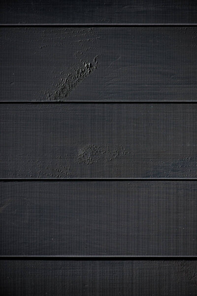 Wood texture. black timber board with weathered crack lines. Natural background for shabby chic design. Black wooden floor image. Aged tree surface close-up backdrop template