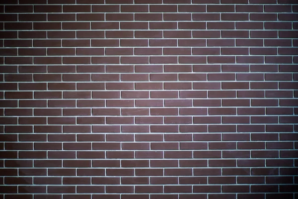 Fondo de una pared de ladrillo oscuro, textura del azulejo con un patrón suave . —  Fotos de Stock