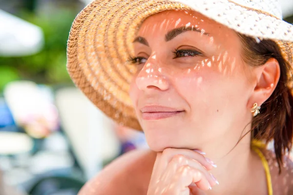 Brunette girl in a straw hat at the sea. Close-up portrait of a woman. Three quarters profile — Stock Photo, Image