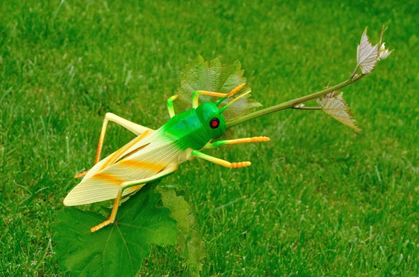 Plastic grasshoppers in the garden Stock Image
