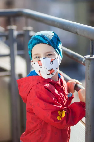 medical mask made of fabric with moped patterns on the child\'s face, protection against viruses, against coronavirus