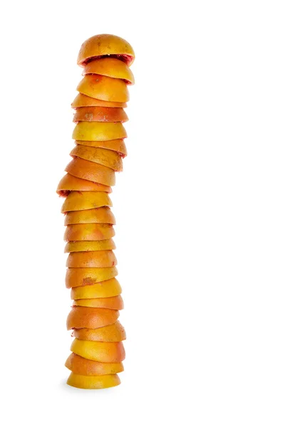 Tall stack of dark orange grapefruit rinds — Stock Photo, Image