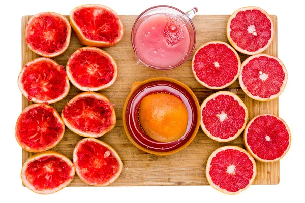 Ruby grapefruit still life with juice and juicer — Stock Photo, Image