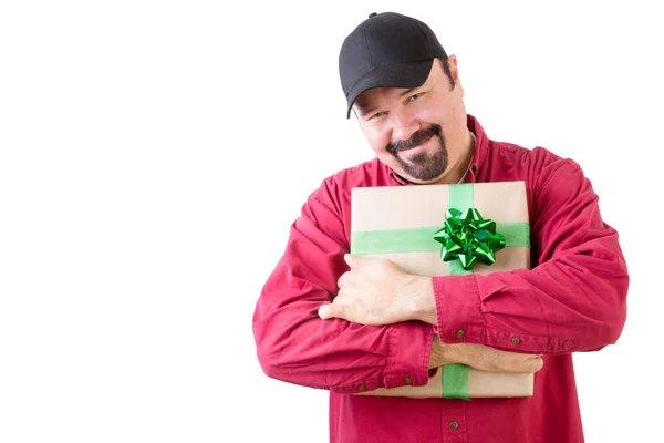 Happy man in hat holding a Christmas gift — Stock Photo, Image