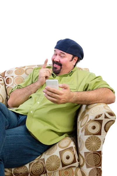 Man in armchair with mobile wagging finger — Stock Photo, Image
