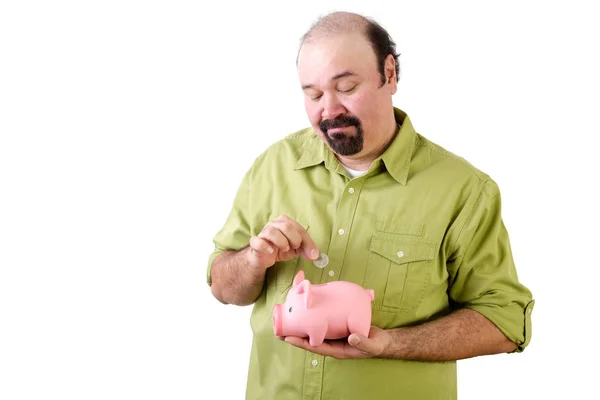 Middle aged man saving money in piggy bank — Stock Photo, Image