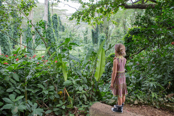 Girl eating lollipop at Na Ala Hele Monoa Falls