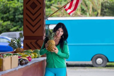 Ananas tutan genç gülümseyen kadın