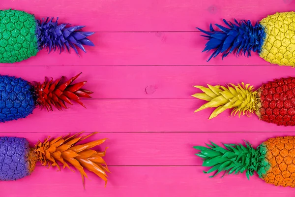 Six brightly colored pineapple tops with leaves — Stock Photo, Image