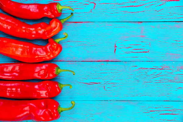 Border of colorful red hot fresh chili peppers — Stock Photo, Image