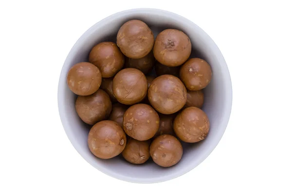 Bowl of fresh macadamia nuts with shells — Stock Photo, Image