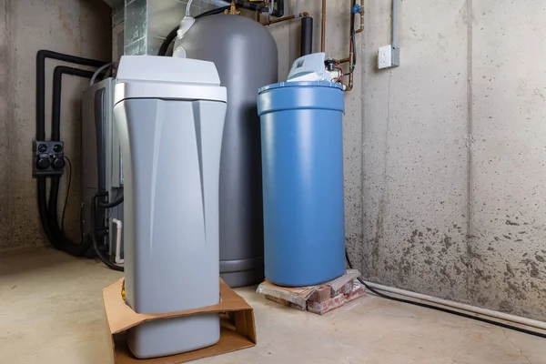 Old and new water softener tanks in a utility room — Stock Photo, Image