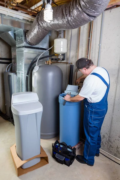 Experienced home installer fixing a water softener — Stock Photo, Image