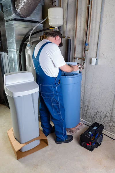 Installer inputting settings on a water softener — Stock Photo, Image