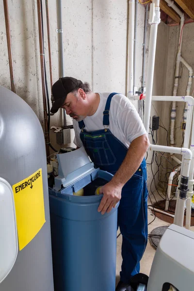 Workman replacing an old domestic water softener — Stock Photo, Image