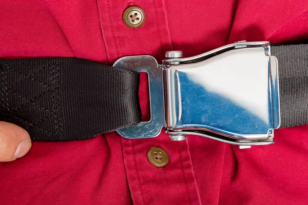 Tightly clinched seat belt buckle on a passenger — Stock Photo, Image