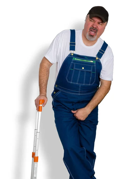 Worker clutching his groin in discomfort — Stock Image Worker clutching his groin in discomfort Stock Picture