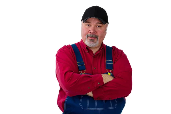 Gardener in dungarees standing with arms crossed — Stock Photo, Image