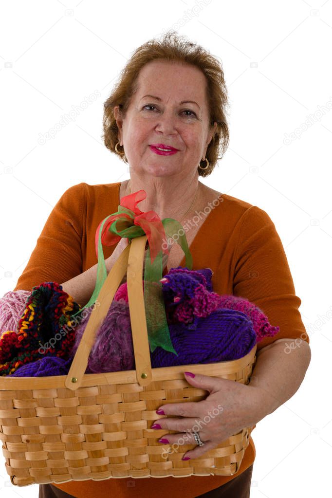 Portrait of senior woman with yarn in basket