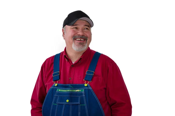 Smiling confident farmer or worker in dungarees — Stock Photo, Image