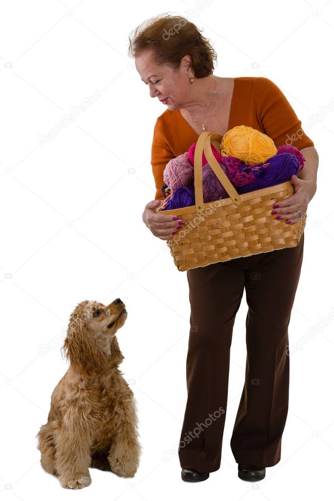 Elderly woman with a basket of wool and her dog