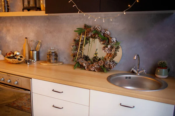 stock image New Years kitchen interior, Christmas wreath hanging on the kitchen wall. Christmas decoration of the kitchen