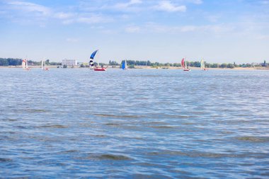 Sailing regatta is on the Volga River. Many yachts with sails on the water